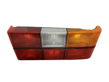 Volvo sedan, 242, 262, 264, 1979-1984 Tail light assembly with six light panels with Black Center Molding, COMPLETE with circuit board, sockets, bulbs. Right side/Passenger side 1307772