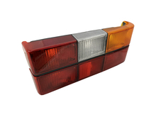 Volvo sedan, 242, 262, 264, 1979-1984 Tail light assembly with six light panels with Black Center Molding, COMPLETE with circuit board, sockets, bulbs. Right side/Passenger side 1307772